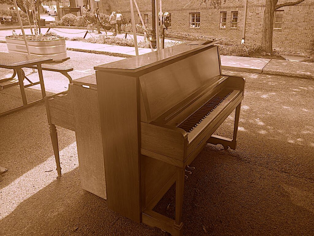4-15-2023
The new downtown piano, repurposed from a church, landed safely under the canopy tents on the Draper Pedestrian Block.  Painting and tuning and a bench coming soon…
The previous piano on the backside has been stowed safely for repurposing into a public art installation.  
